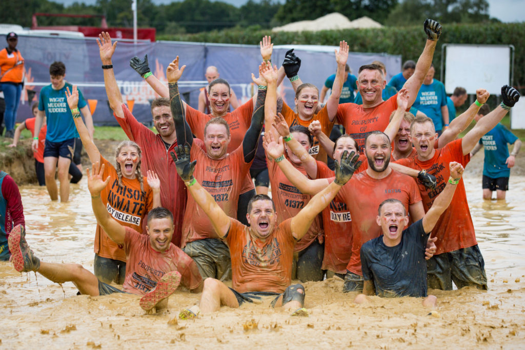 Team in red t-shirts in mud