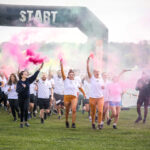 runners with flares three fold takes on Tough Mudder